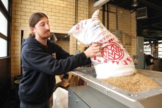 Owner pours kernels into the mill