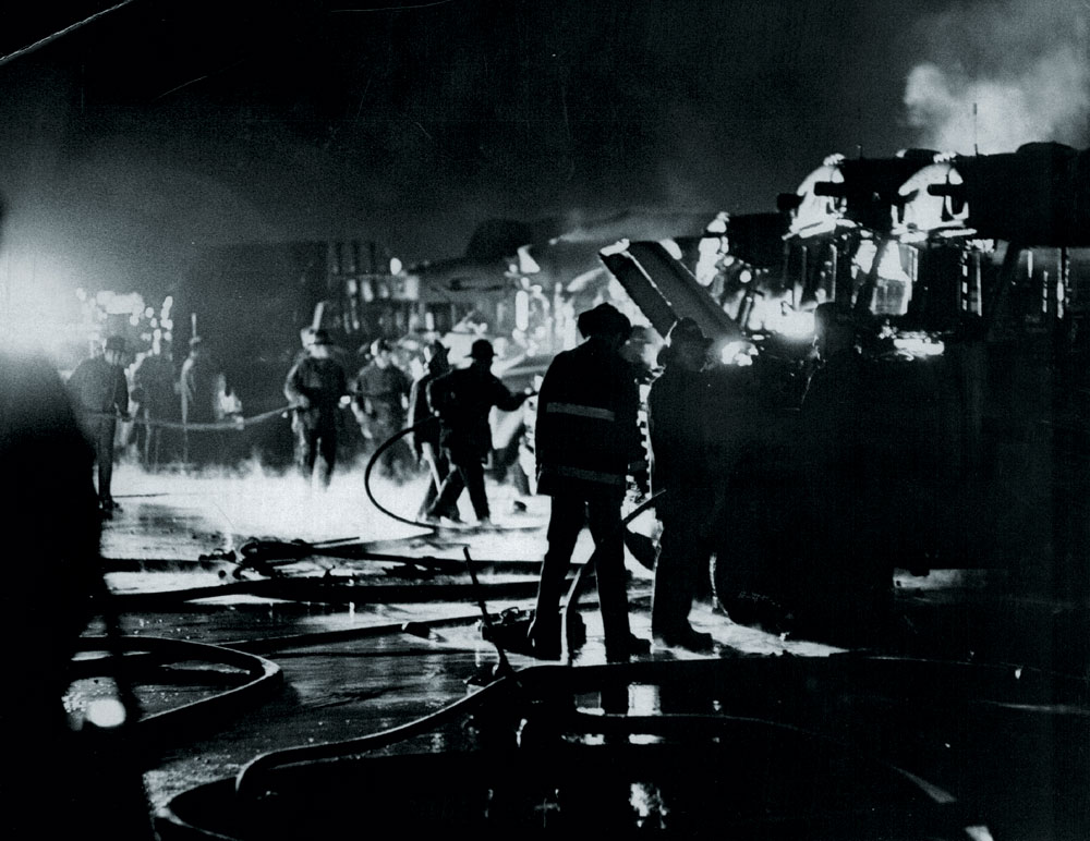 Firemen hose down the buses in the February 1970 bus bombing. No one knows who did the bombing and no one claimed responsibility, but it has been assumed that it was related to racial tensions. Photo by Steve Larson—Denver Post file photo