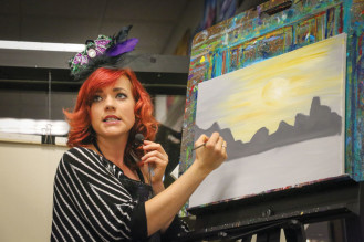 Instructor, Kelly Crowe, shows how to paint a scene at dusk.