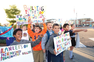 Students chanted and held anti-bullying signs in front of Bill Roberts K-8 school.