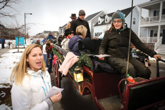 Kaia Nesbitt (left) checks in families for the sleigh ride.