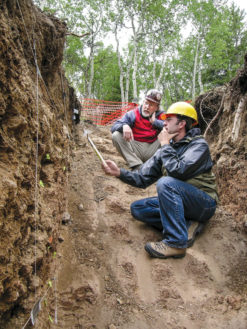 Geologists Matt Morgan and Robert Kirkham of the Colorado Geological Survey examine evidence for movement along a fault, after trenching through soils deformed by the fault and mapping their internal structure. Photo by Dave Noe 