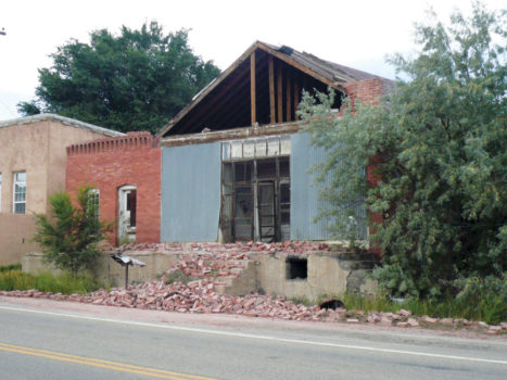 Collapsed front of a brick building (note crushed mailbox) in Segundo, CO, after the 2011 Trinidad, CO earthquake. Photo by Matt Morgan
