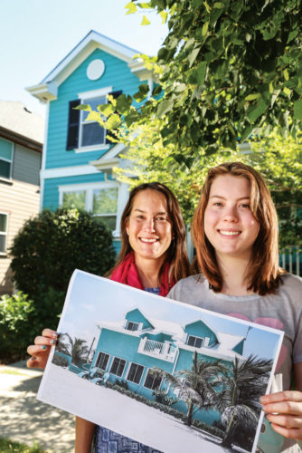 Allison Fisher, 17, (right) holds a picture of a home in the Caribbean. The bright colors of the tropics were the inspiration for their Stapleton home when it was time for new paint. Trish Fisher let Allison select the color while she and her husband were on vacation.