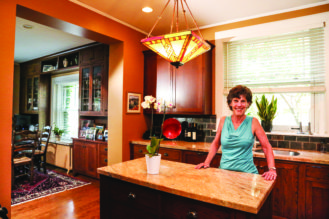 Sandra Stenmark stands in her kitchen, which was remodeled to reflect the period features of the home.