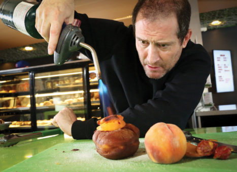 Josh Schwab caramelizes a peach pastry.