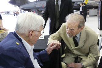 Lester (Bill) Zinser (left), a retired major who flew B-52s in World War II introduces himself to sculptor Fredric Arnold, now more than 90 years old, at the unveiling event at Wings Over the Rockies.