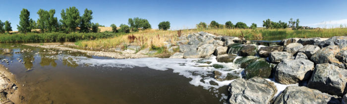 The confluence of Westerly Creek with Sand Creek is visible in the background. 