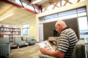 An adult patron reading at the Sam Gary Library.