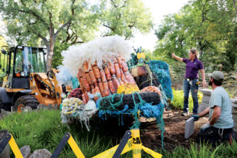  Pozzi adjusts plastic bags on the “Anemone Garden” sculpture as it is being installed.