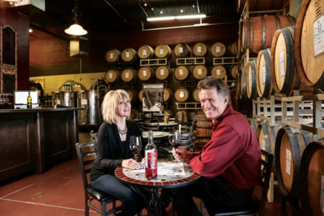 Doug and Karen Kingman enjoy the fruits of their labors—a glass of wine at their winery.