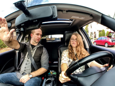 Ryan Badger, owner of Badger Driving School LLC, instructs 15-year-old student Carolyn Elsner. Badger uses a car equipped with a brake on his side if needed for safety when he is out instructing new drivers.