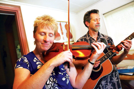 Josie Quick and Tom Carleno are musicians who perform together and give private lessons from their home.