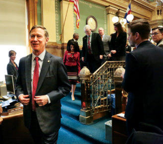 Governor John Hickenlooper leaves the podium after making his State of the State address to the combined house and senate in the house chamber.