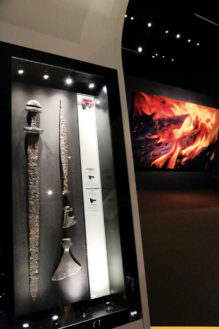An ax and a sword are among the crafts and tools on display. Display cases show the ‘workbench’ of tools used to craft a product, the raw materials used, and the finished product. Axes were more common than swords, so axes were often used in battle.