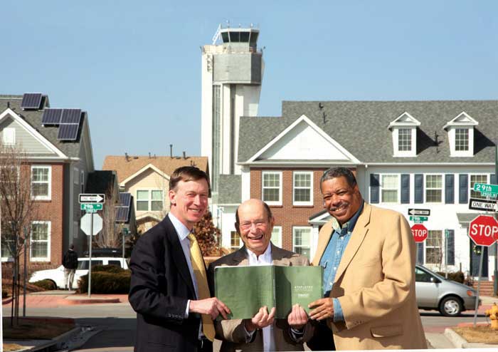 Hickenlooper, Webb and Sam Gary holding The Green Book.