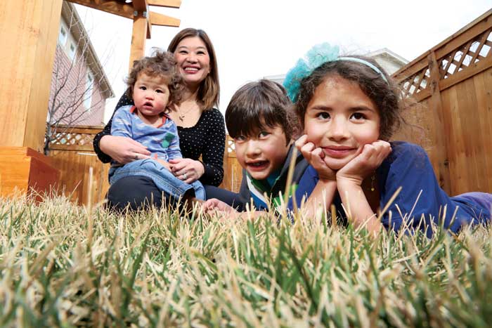 Dr. Kanao Otsu enjoys a warm afternoon in her Stapleton backyard with her three children, left to right:  Micah, 23 months, Kai, 9, and Sylvie, 7.