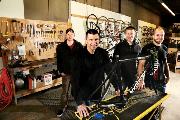 Giantnerd staff, all cyclists, are pictured in their warehouse near Stapleton: (left to right) warehouse manager Jake Knobbe, owner Mike Eddy, operations manager Justin Essler and marketing and sales manager Chris Schuerman.