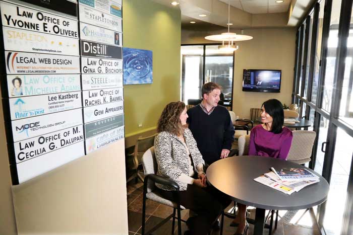 A group meets at SmartSpace in Stapleton, which provides office space for small and home businesses that don’t need full offices. Left to right: Architecture and design construction management owners Heather and Kevin Calme and lawyer Yvonne Olivere.