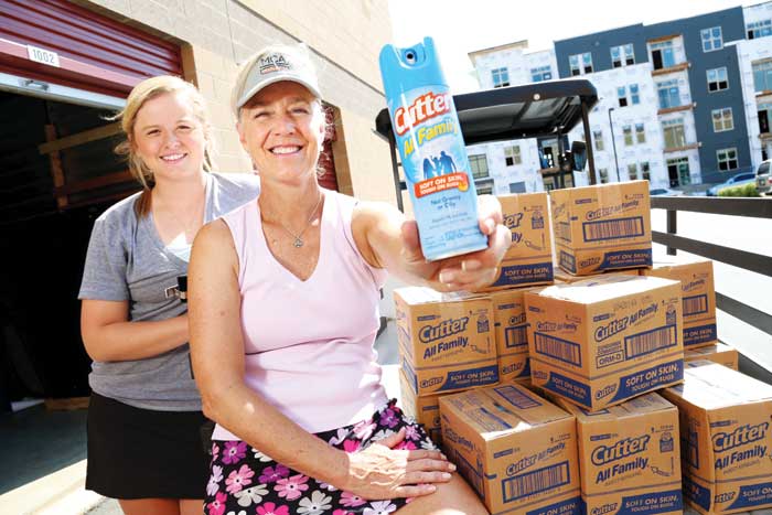 The manufacturers of Cutter Insect Repellent sent 2,000 cans of spray to the Stapleton MCA to distribute free during outdoor events this summer. MCA intern Lexie Deeter and her aunt, Diane Deeter, MCA Program Director, prepare to distribute repellent to the pools.