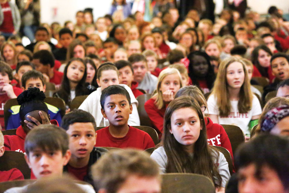 McAuliffe International School students attend an all-school event in their auditorium. 