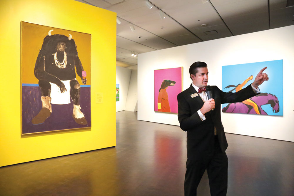 Exhibit curator John Lukavic, a Park Hill resident, guides visitors through the Fritz Scholder exhibit at the Denver Museum of Art.
