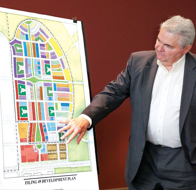 Forest City VP Tom Gleason points toward the commercial area (light red) and rental apartments (brownish) along 56th Ave. in Forest City’s preliminary plan for the new neighborhood north of 56th. Affordable for-sale homes are shown in red along CPB (the west border).