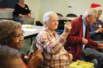 Dorothy McNeese and her fellow cafe-goers make music with bells and other instruments.