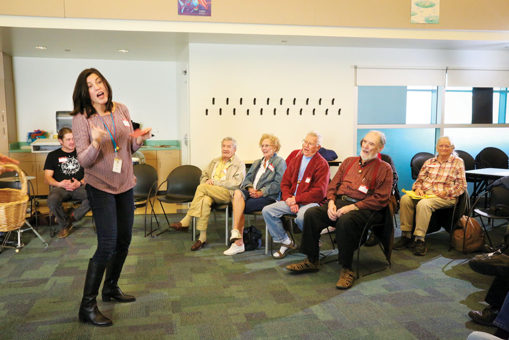 Reference Librarian, Amy DelPo takes a turn leading the group in songs. DelPo was inspired to start the Memory Cafe at the library by her own mother, who has Alzheimer’s Disease. 
