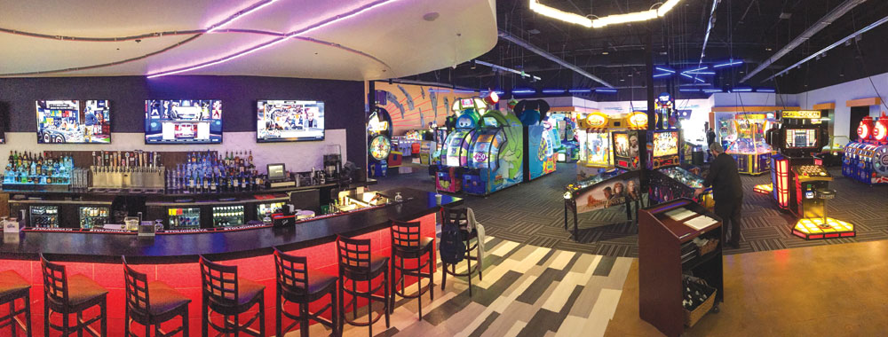 A panorama shows the bar and dining area at left and games at right. 