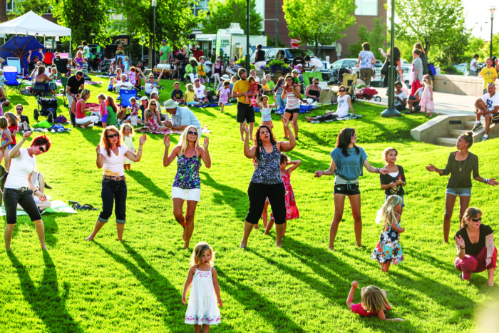 Concert-goers dance at one of the many free and open to the public events at Stapleton’s Greens.