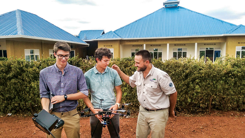 Nathan Lepore (left) and DSST classmate Max Alger-Meyer are pictured with a park ranger in Rwanda. Lepore and Alger-Meyer taught the rangers how to use and maintain the drone they invented and donated. Photo courtesy of Nathan Lepore