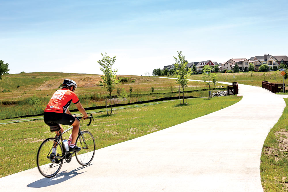 A bicycle rider passes through the newly finished Westerly Creek North open space. A celebration of the completion of the project will be held at 8:30am on August 17 at E. 35th Ave and Dayton St. 