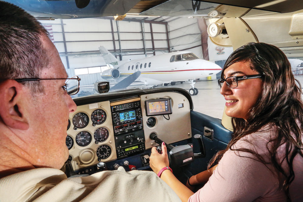 Chief Pilot at Front Range Fight School, Brian Eaton talks with student Briana Fraire, who will be graduating from Metro State University with a degree in aviation this spring.