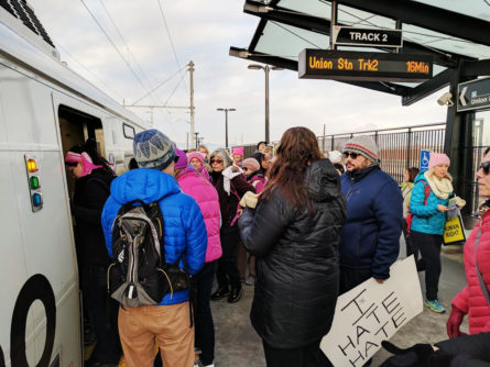 At 8am, nearby residents filled the platform at Central Park Station en route to the Women's March. Photo by Amanda Allshouse.