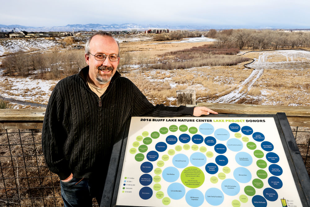 Jeff Lamontagne is pictured with a plaque that lists donors to the Bluff Lake project that rebuilt the 132-year-old dam and sealed the lake bed so it will have water year round.