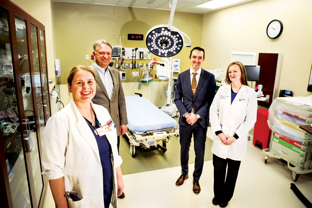 Dr. Ashley Mull, Dr. Andrew Ziller, emergency services director Steve Forbes, and nurse manager Mary Corcoran. The primary trauma room includes resuscitation equipment and a telemedicine link to neurology, pediatrics, and psychology, allowing off-site providers to robotically examine patients and advise treating physicians.
