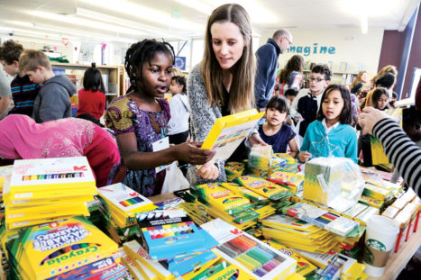 ESL Teacher Sophie Glover, along with many parent volunteers from the mainstream side of the school, were on hand at the event to help students like Busime Matabishi choose books and art supplies.