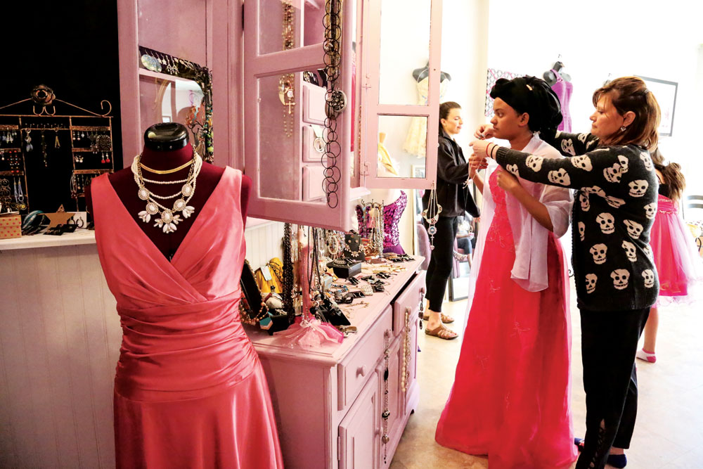Starr Temple-Nienaber helps Sabrin Mohamed, North HS, select accessories to complete her outfit. 
