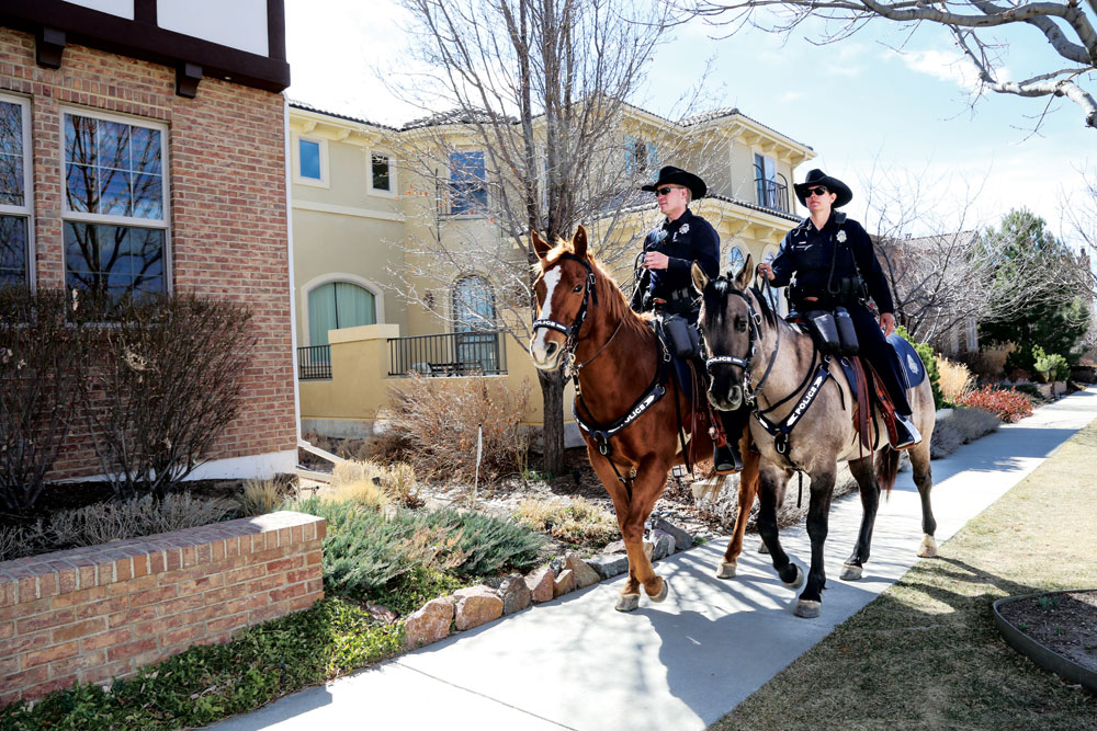 Officers Matt Peltier on “Jackson” and Kim Quintana on “Blue“ (left) rode through the Eastbridge neighborhood of Stapleton.