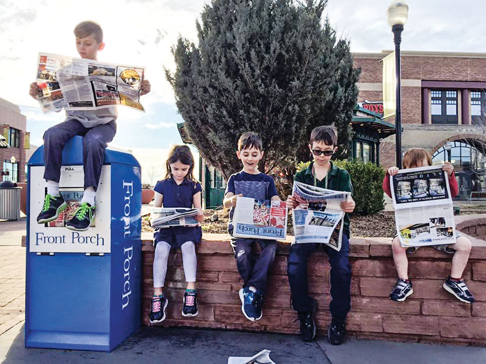 Who says print journalism is dead? Maybe not for the next generation. These five young people appear to be avid newspaper readers: (left to right) Brody Goldsmith (on paper stand), Phoebe Stabio, Hadley Goldsmith, Oliver Stabio, William Stabio.