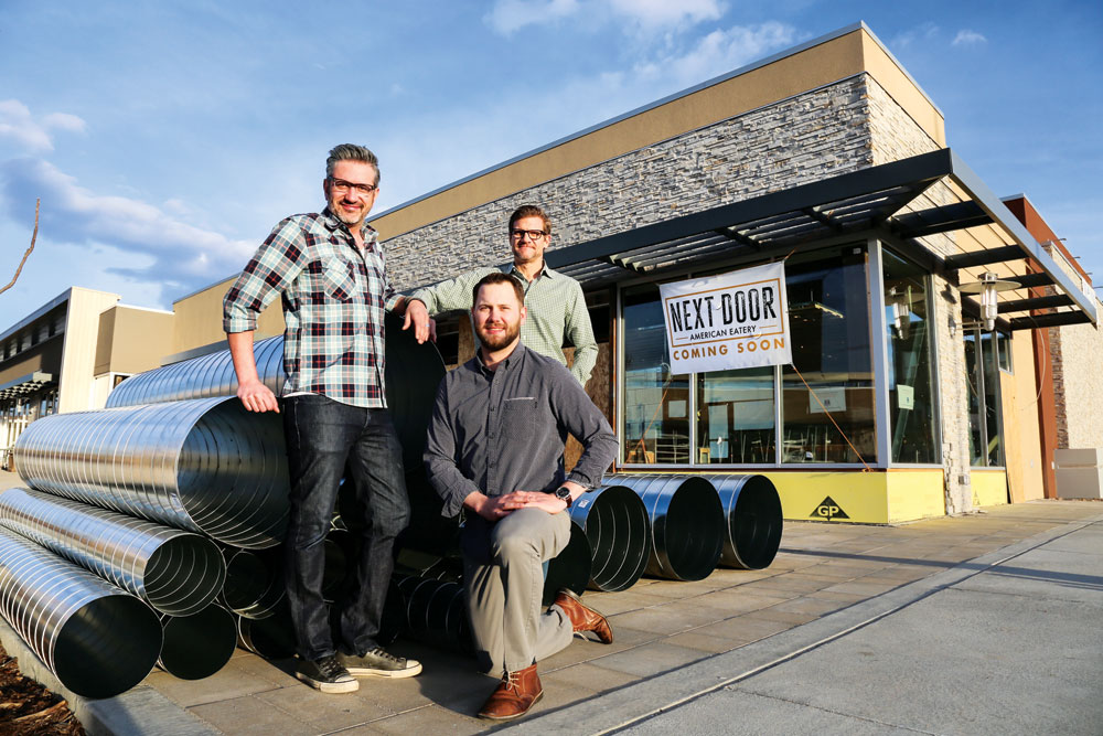 Merlin Verrier, culinary director, (left), Chris Calcaterra, GM, and Colin Ness, director of operations gather at their about-to-open Eastbridge restaurant, Next Door, which is a part of The Kitchen Restaurant Group. Verrier and Ness live nearby in Stapleton.