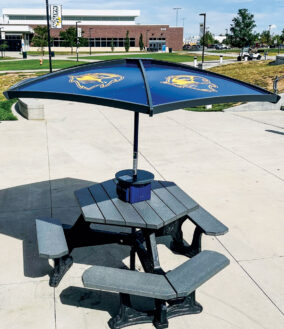 The umbrellas on the picnic table feature solar panels and the Northfield logo.